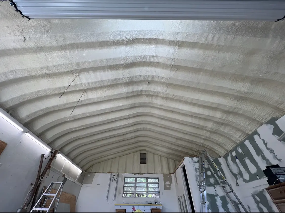 Spray polyurethane foam applied to the underside of a metal roof deck in Brookshire
